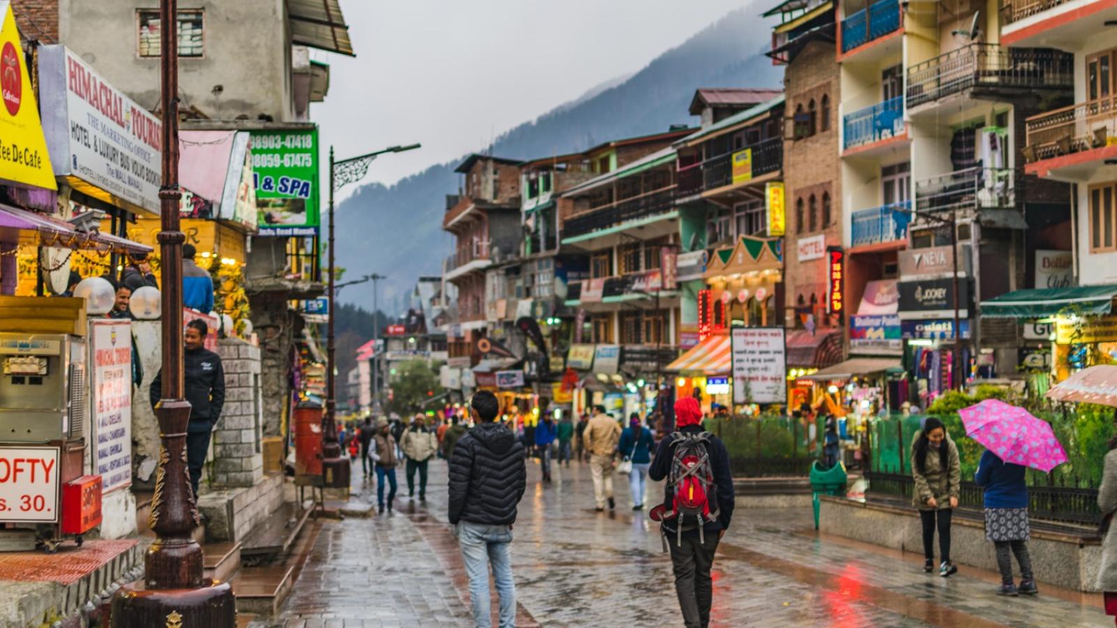 Pedestrians walking on a sidewalk in an Indian city