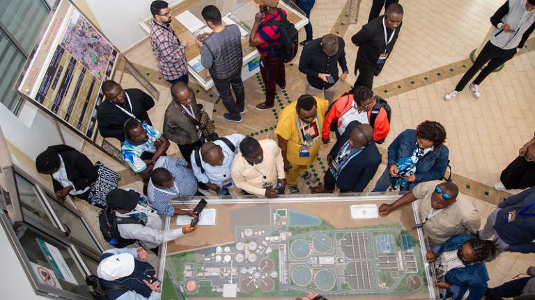 participants in the marrakech city academy looking at a model of the city