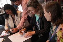 Women working on city academy course materials